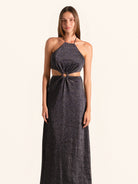 Front view of black sequined halter cut out maxi dress with ring detail