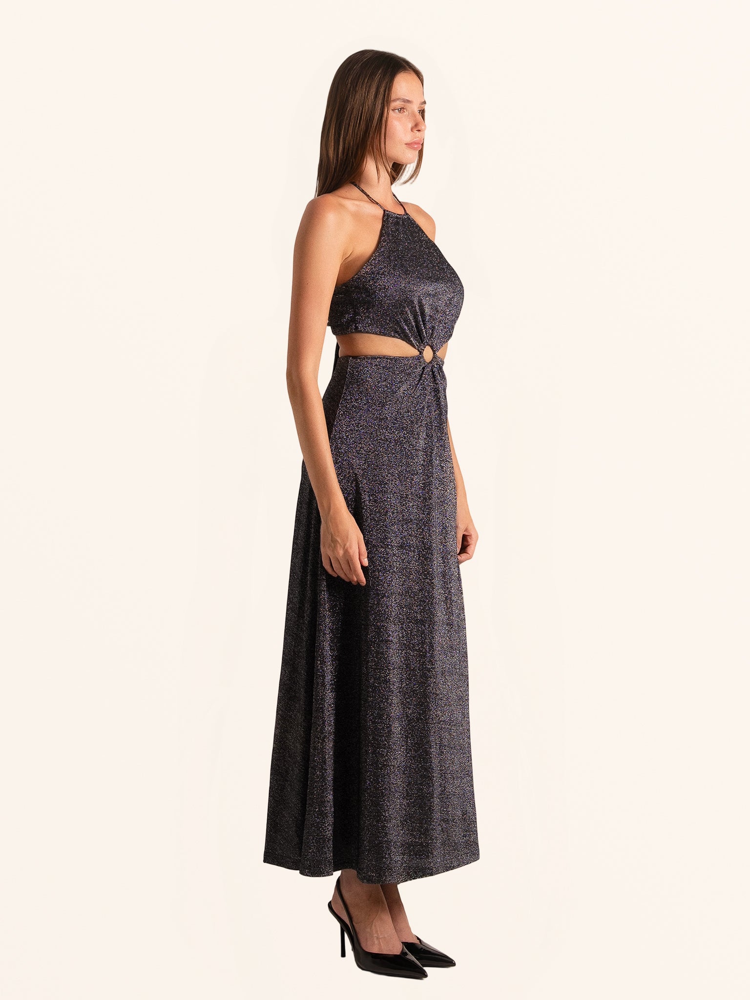 Side profile of black sequined maxi dress with open back and cut out detail