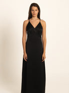 Front view of black spaghetti strap maxi dress with deep V neckline