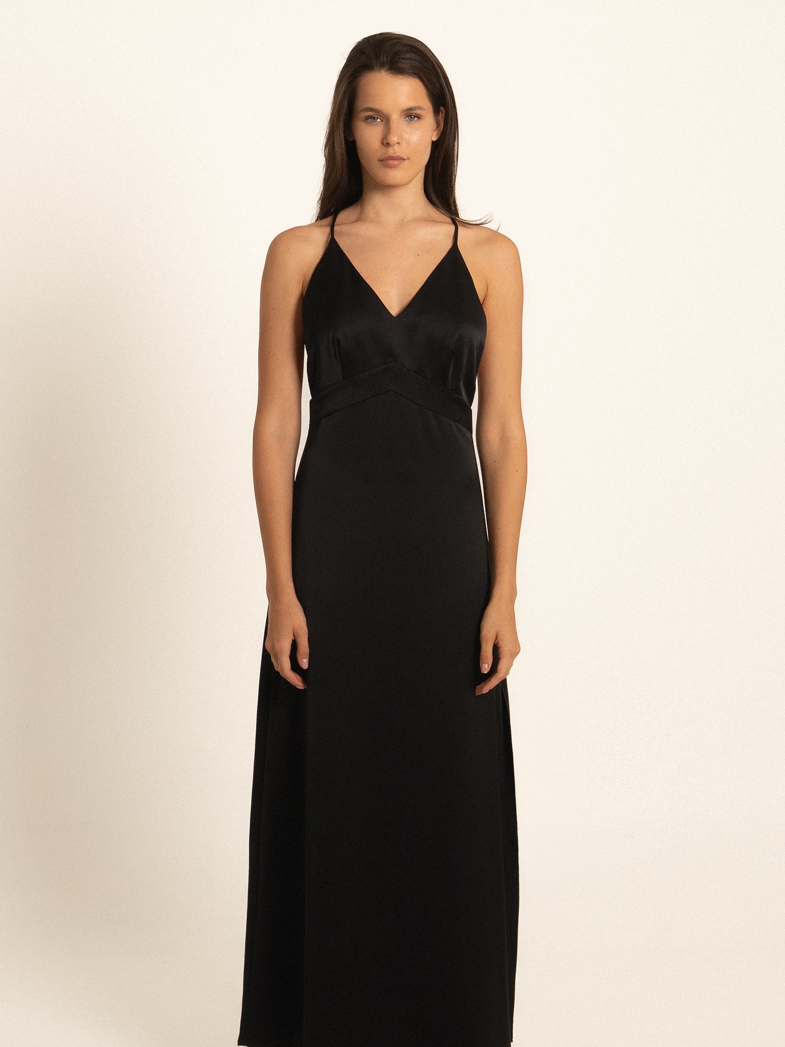 Front view of black spaghetti strap maxi dress with deep V neckline
