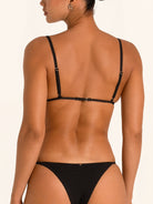 Back view of black triangle bikini top with thin straps and clasp closure.
