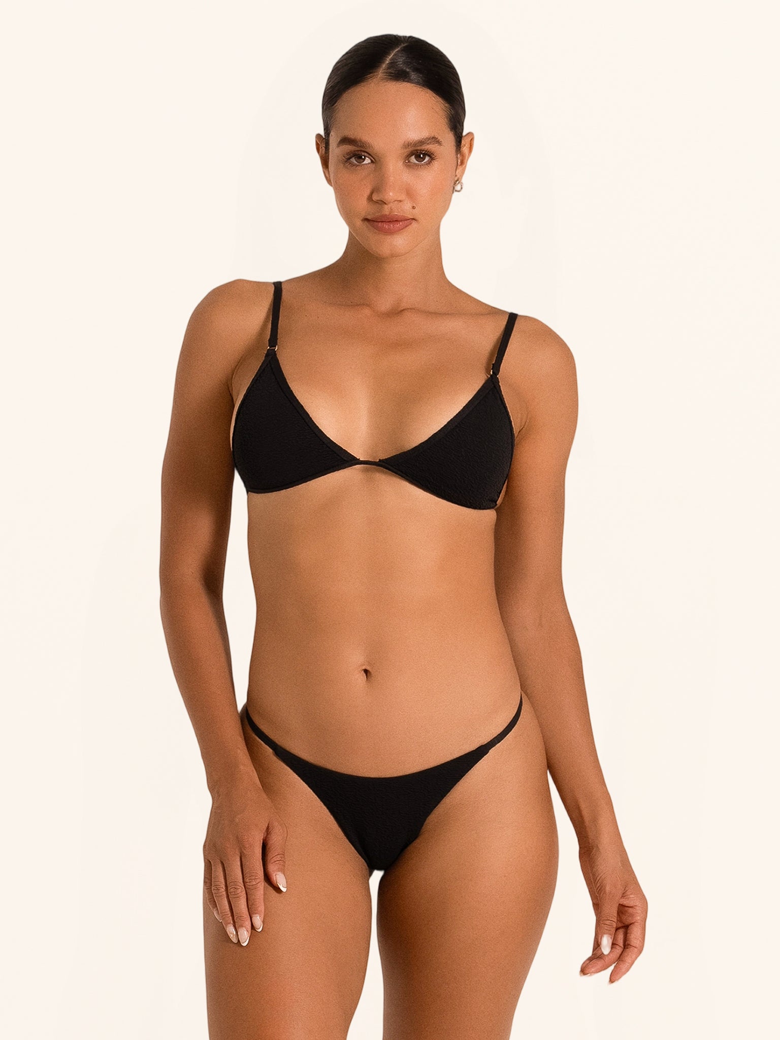 Front view of black triangle bikini top with thin adjustable straps and minimal design.