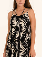 Side profile of black and white leaf print midi dress with relaxed fit