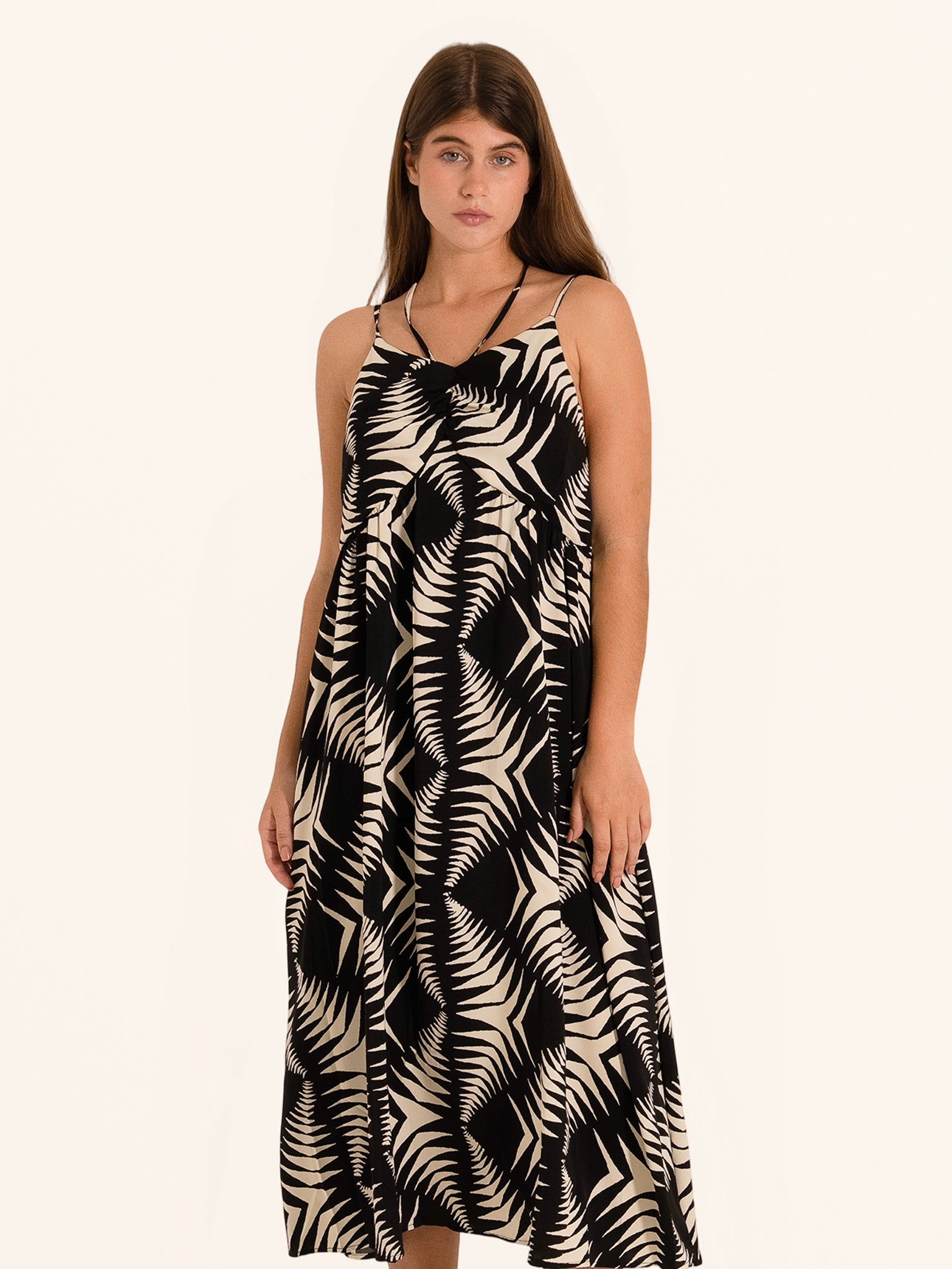 Front view of black and white leaf print midi dress with spaghetti straps