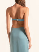Back view of blue green strapless dress with open back cut out design
