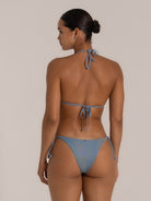 Back view of a blue-grey textured triangle bikini top with halter tie straps.