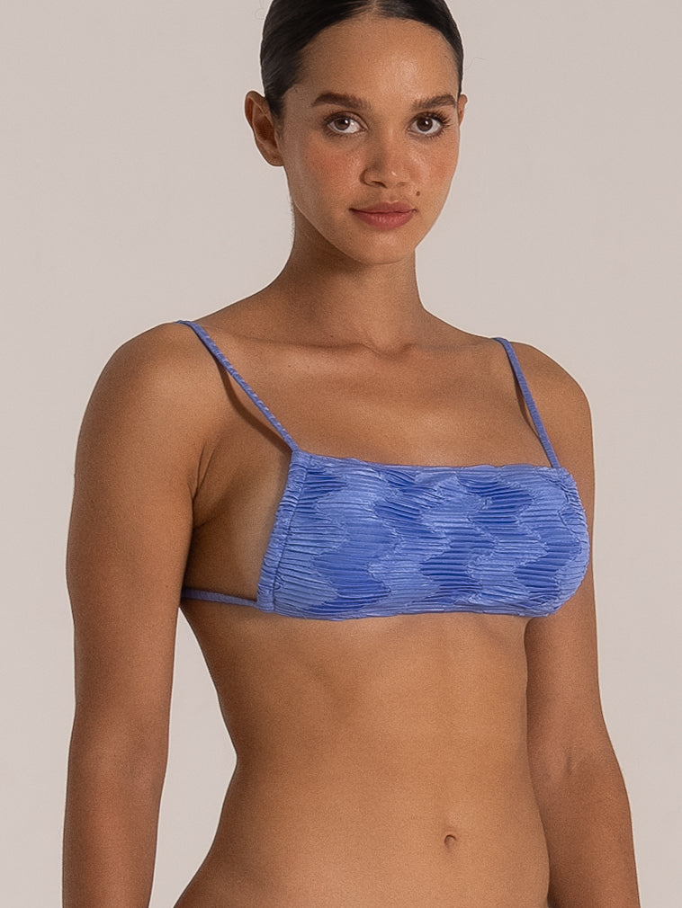 Side angle of textured square bikini top in ocean blue with slim shoulder straps and soft ribbed pattern