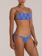 Blue square-neck bikini set with adjustable spaghetti straps and ruched fabric, front side angle
