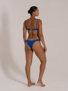 Angled back view of blue textured bikini set with underwire top and cheeky bottom