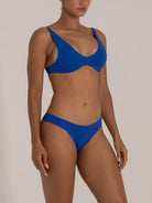 Side view of a blue underwire bikini set featuring wide straps and supportive fit in textured fabric.