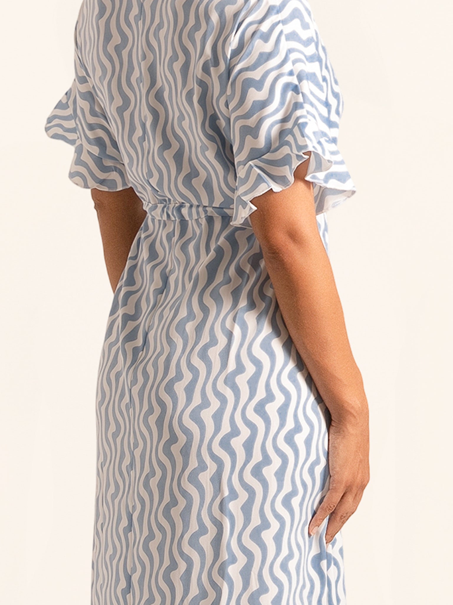 Side profile of blue and white print maxi dress with belted waist
