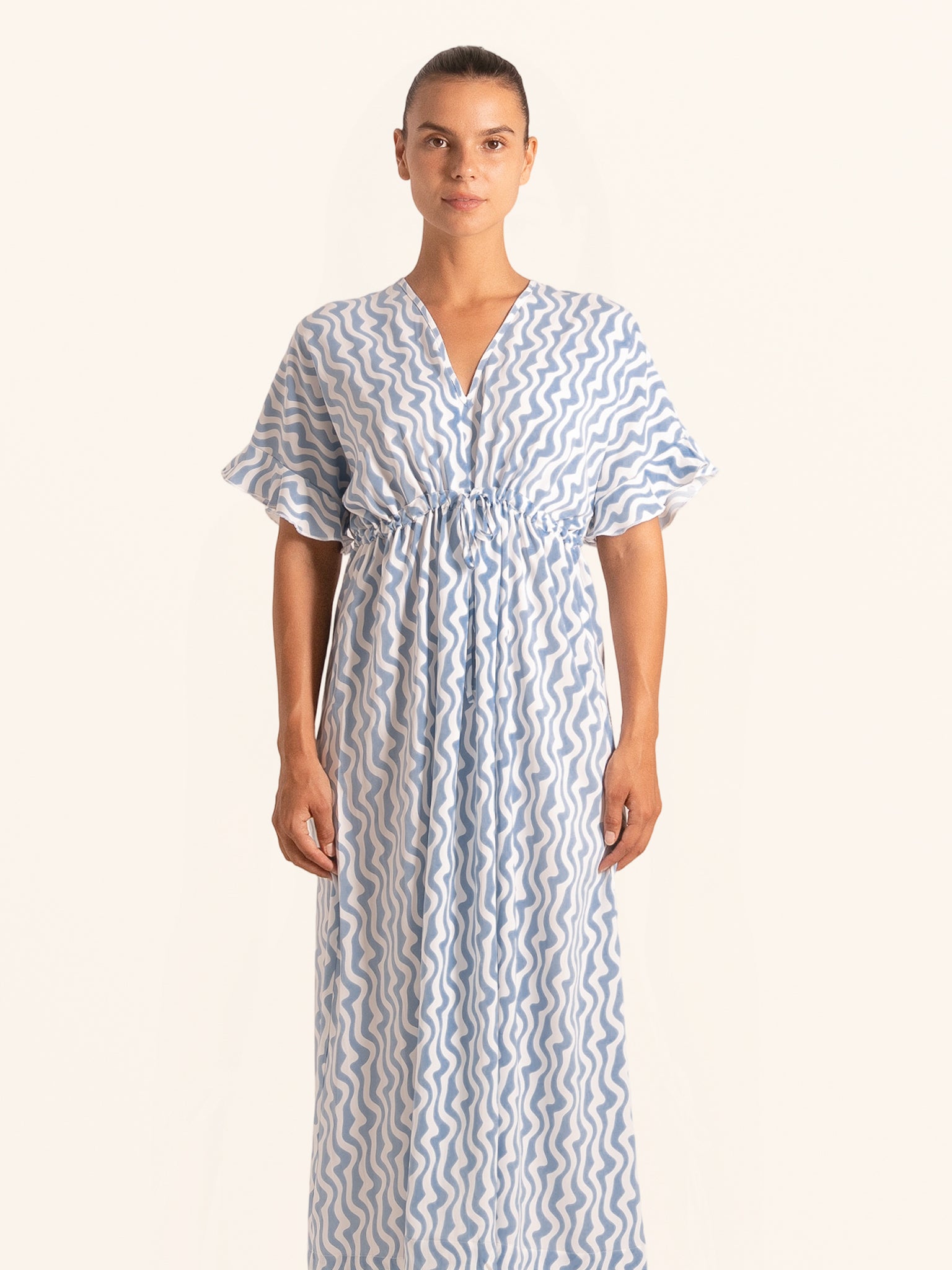 Front view of blue and white printed maxi dress with V neckline and tie waist