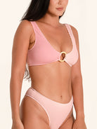 Blush pink bikini top featuring a statement ring accent.