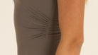 Close-up detail of the premium nylon fabric and elegant side ruching on the charcoal gray one-piece swimsuit.