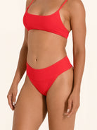 Cheeky bikini pant in vibrant red swimwear style.
