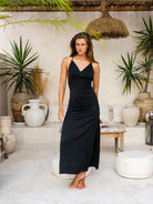 Chic woman wearing a black dress with a side slit for a modern look