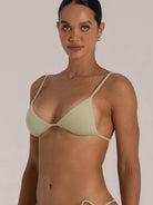 Close-up of ribbed triangle bikini top in light green with adjustable shoulder straps