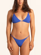 Cobalt blue bikini bottom in cheeky cut swimwear style.