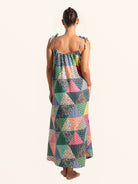 Back full body view of colorful patchwork maxi dress with flowy hem