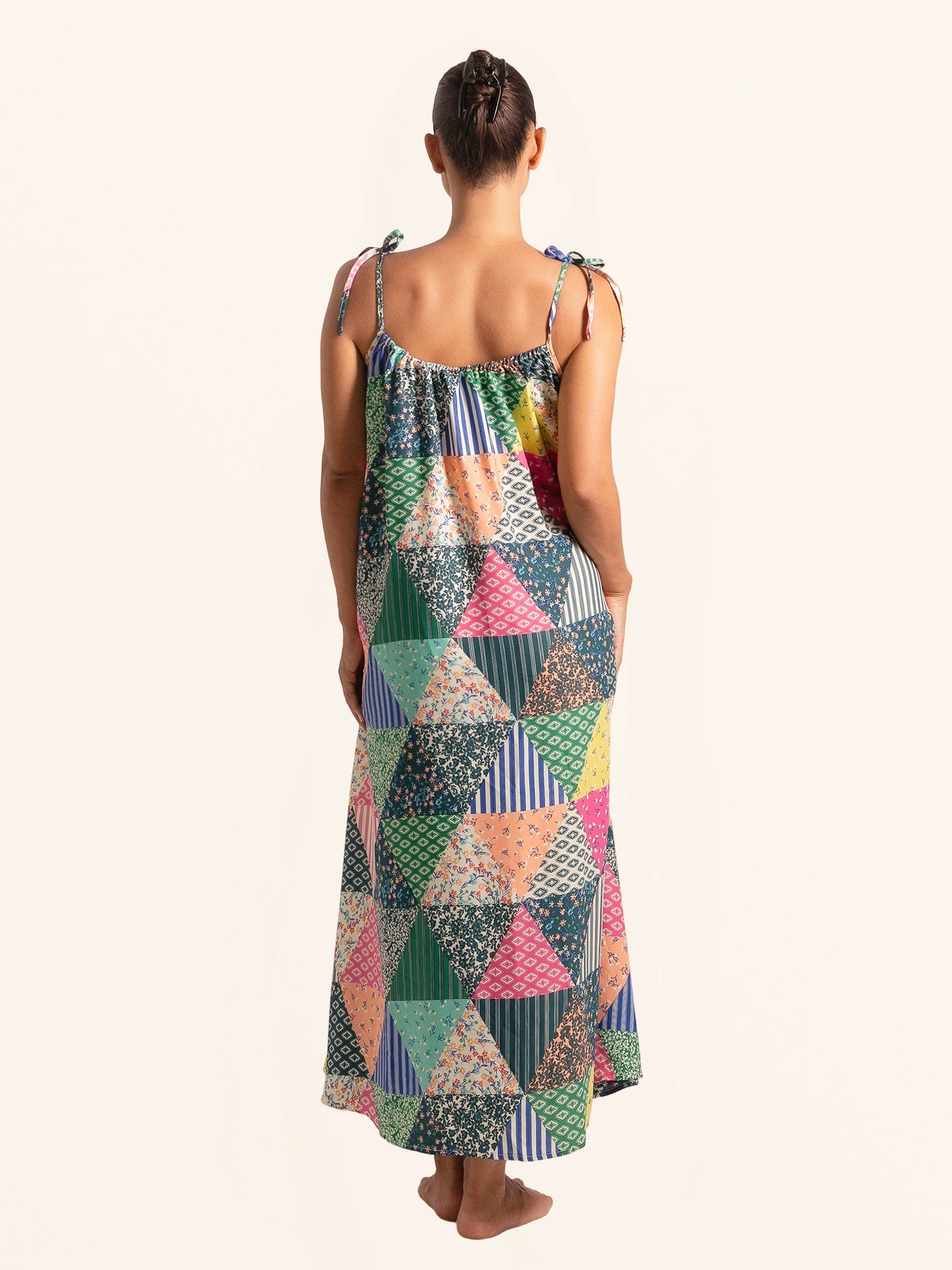 Back full body view of colorful patchwork maxi dress with flowy hem