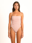 Front view of the Coral Gingham Shirred One-Piece on a model, showcasing the retro square neckline and tummy smoothing full body ruching in peachy pink and white.