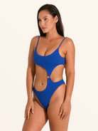 Back view of blue textured cut out one piece swimsuit showing waist cutouts and scoop back.