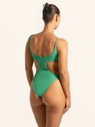 Back view of green textured cut out one piece swimsuit showing waist cutout design.