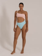 Front view of a pink and blue one-shoulder bikini with cutout detailing and tortoiseshell ring accents.