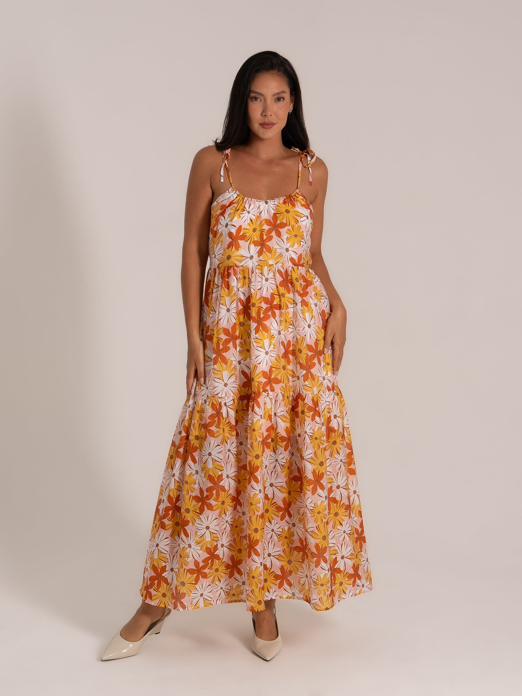 Full-length view of orange and yellow daisy print summer dress