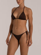 Close-up of deep brown tie-side bikini on model – classic triangle cut with adjustable strings