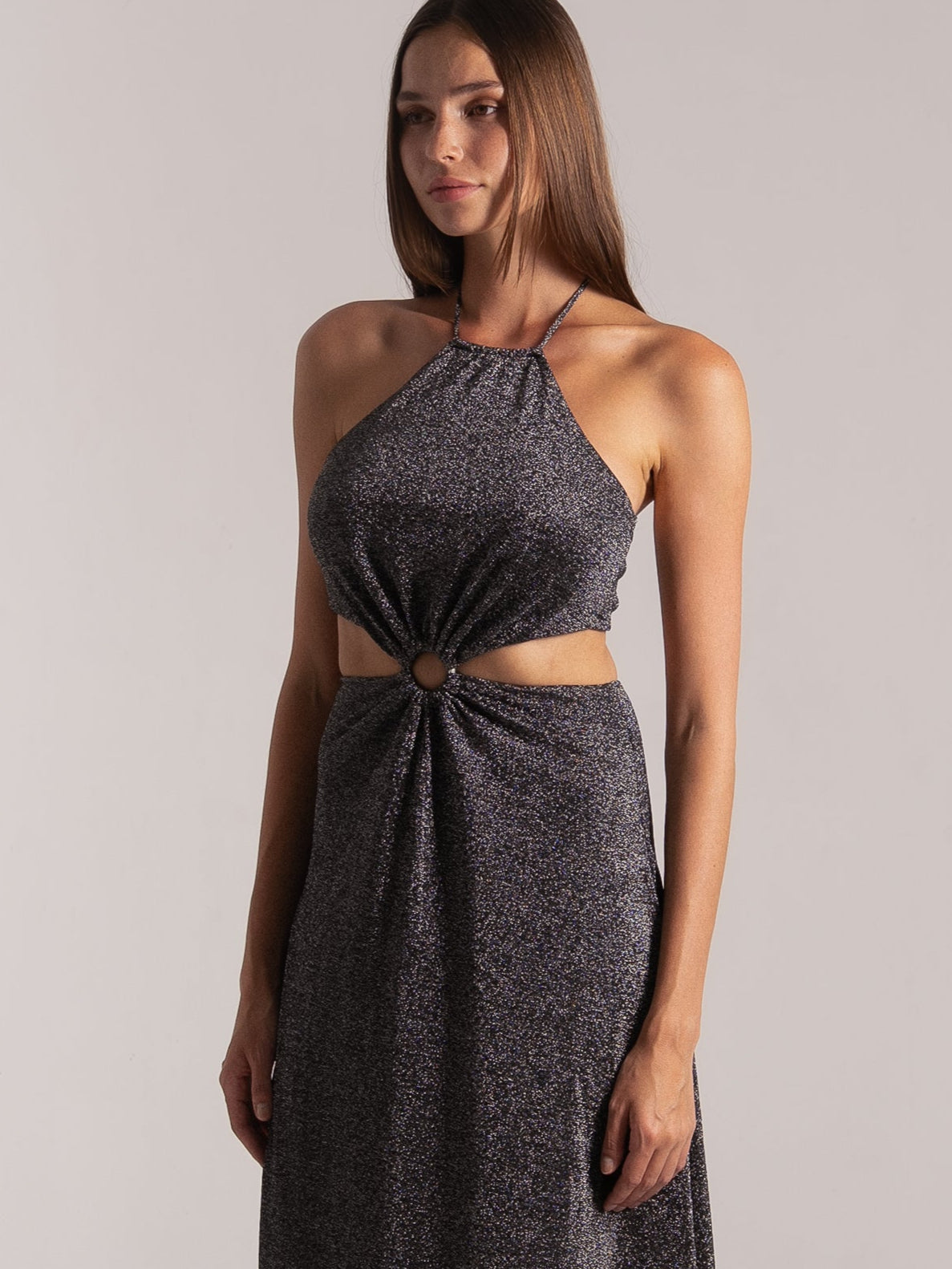 Three-quarter view of dark shimmer halter cutout maxi dress