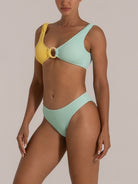 Angled view of mint green textured bikini bottom with clean high-leg silhouette