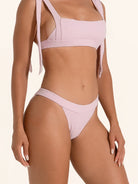 Dusty pink bikini bottom featuring a high cut leg opening.
