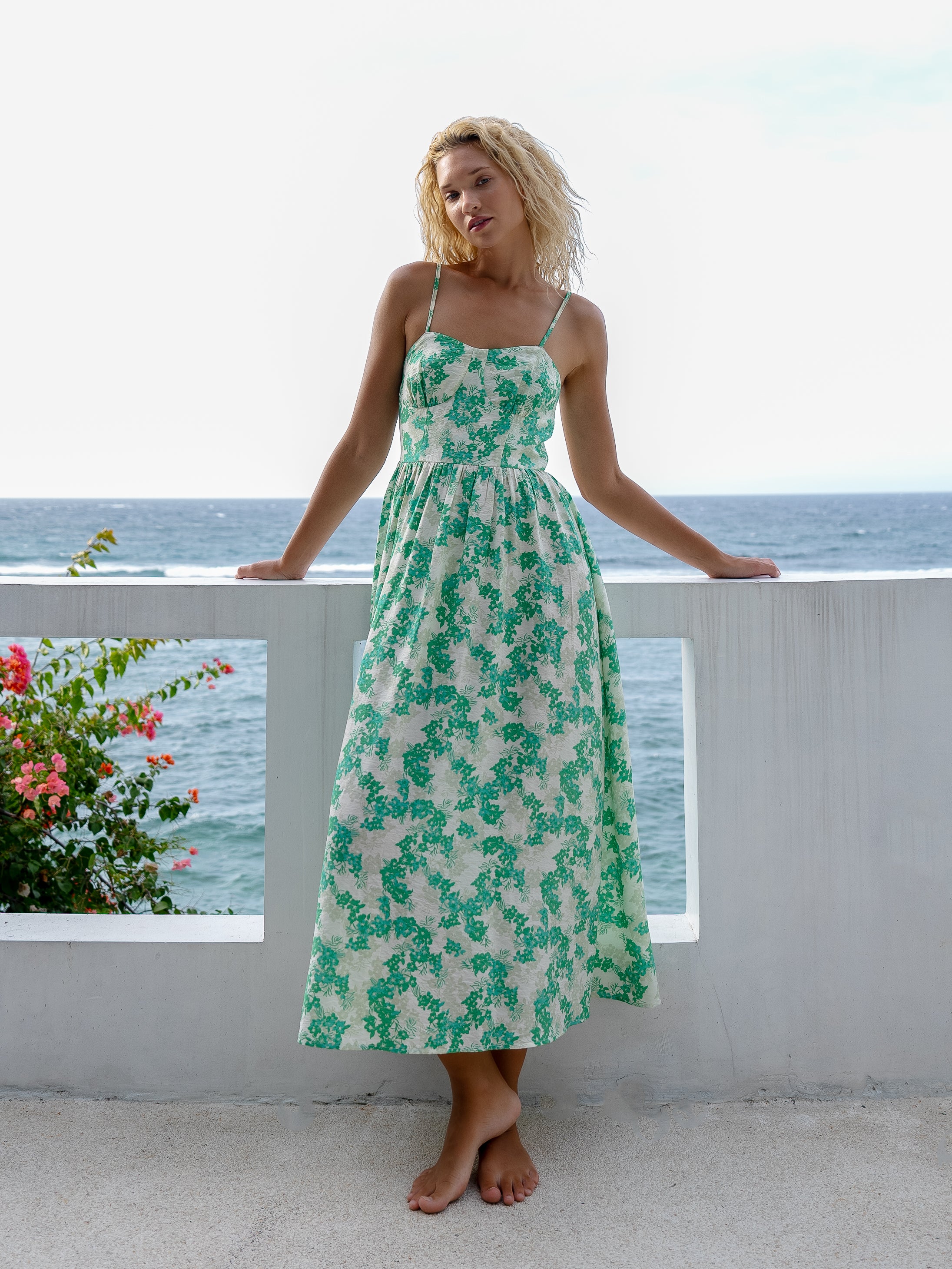 Elegant green floral dress with spaghetti straps and a flared bell skirt