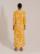 Rear view of yellow and white printed maxi dress with mandarin collar