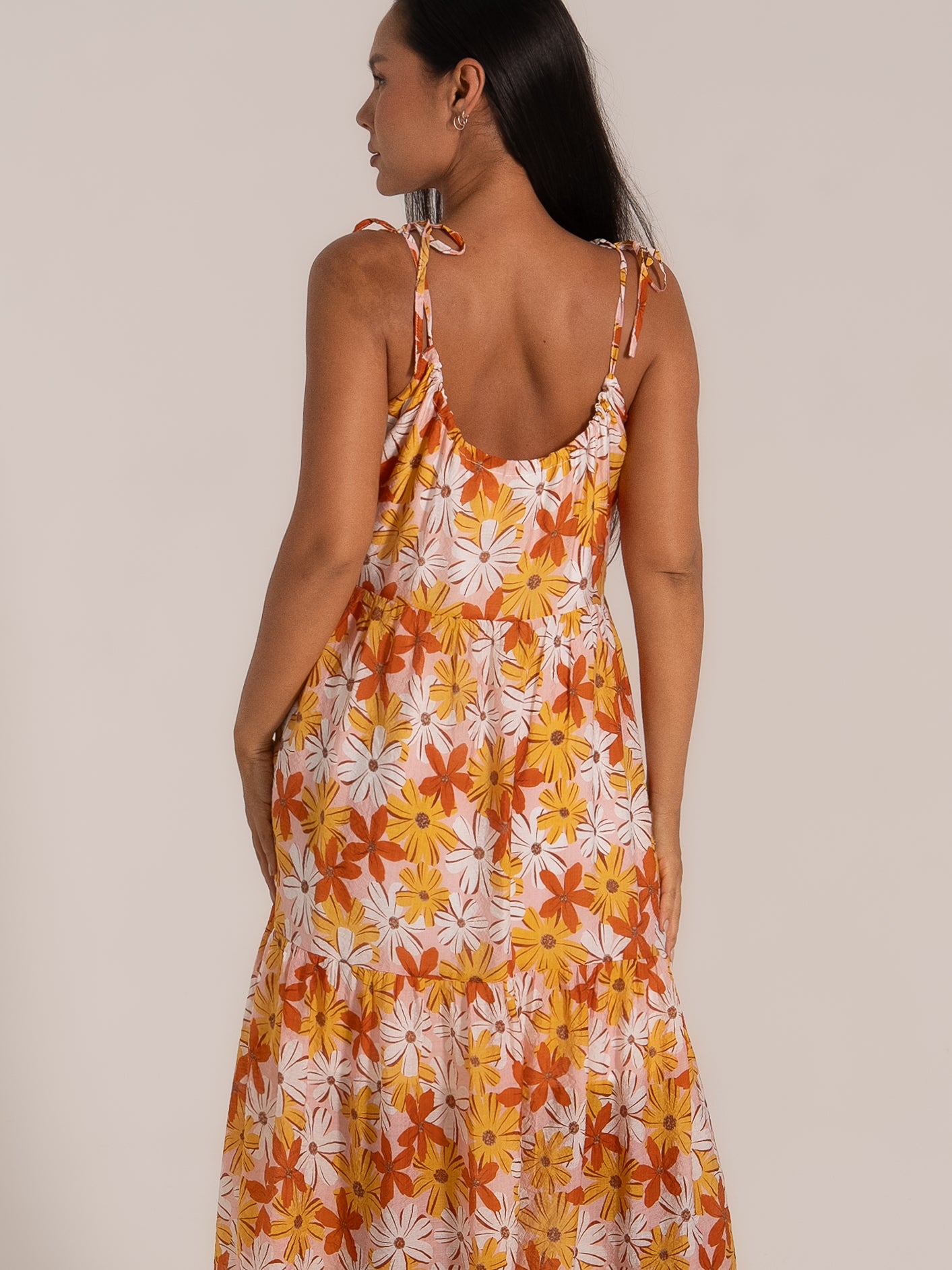  Back view of floral print maxi dress with adjustable tie straps