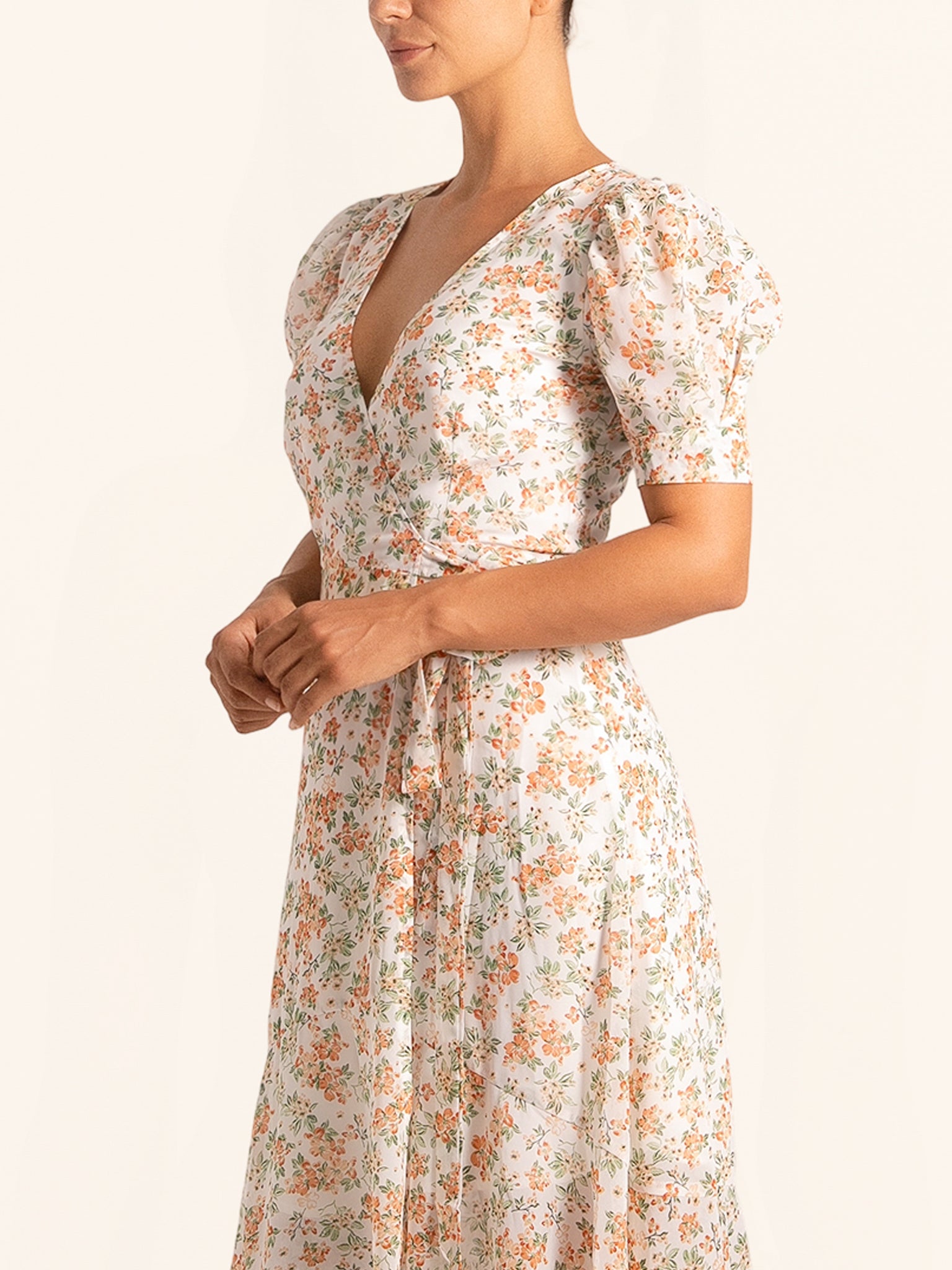 Closeup side angle of floral wrap dress with V neckline and floral print