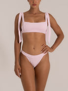 Front-facing image of light pink bikini bottom with soft texture and modern cut
