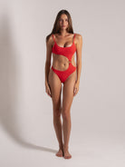 Front view of red cutout one-piece swimsuit with ring detail