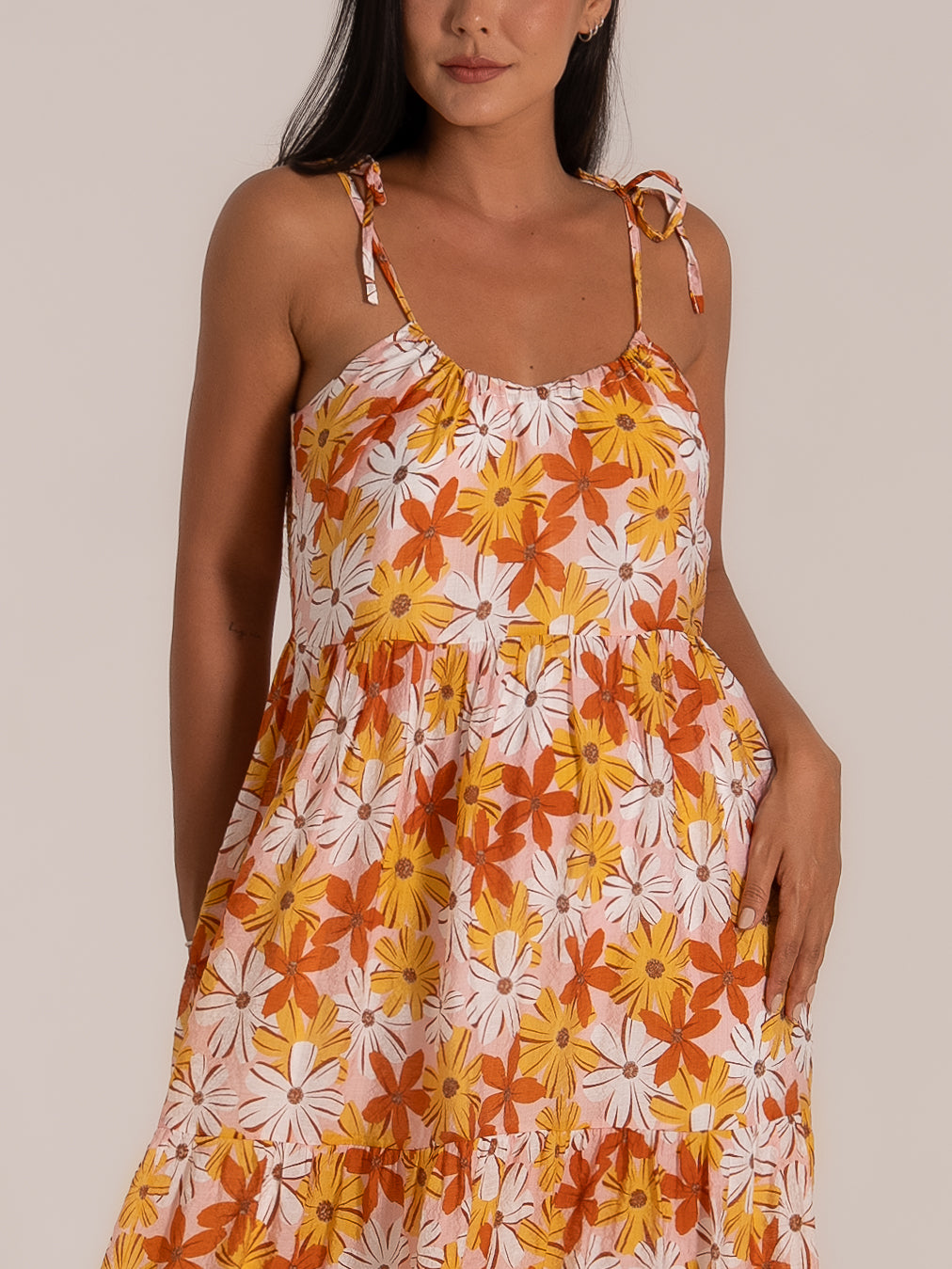 Front close-up of gathered bust and tiered skirt on floral print maxi dress