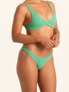 Side profile of green bikini bottom showing flattering fit and sculpted design.