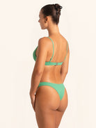 Over shoulder view of green bikini top highlighting flattering fit and textured detail.