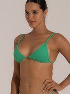 Side angle close-up of green triangle bikini top showing flattering fit and fine texture.