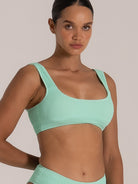 Side view of green textured bikini top showing ribbed fabric details