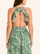 Back view of green floral maxi dress with bow tie straps and open back