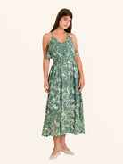 ull body front view of green floral maxi dress with flowing hemline
