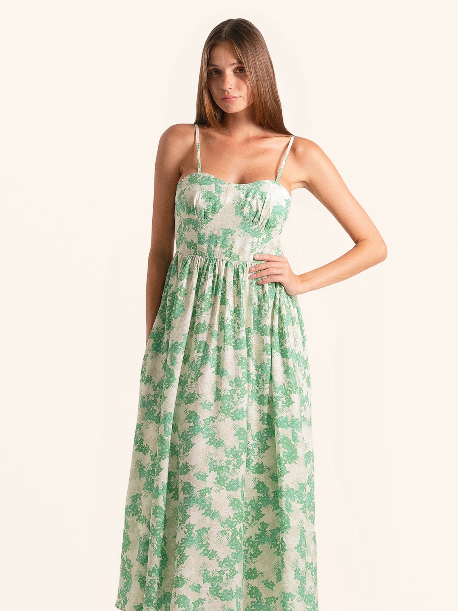 Front view of green floral midi dress with sweetheart neckline and flowing skirt