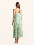 Rear side profile of green floral midi dress with slim straps and relaxed fit