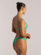 Back view of green triangle bikini top with adjustable straps and textured fabric