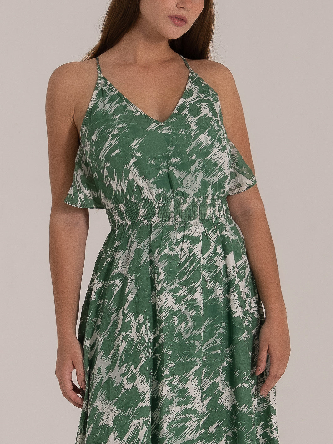Front view of green printed summer dress with smocked waist and ruffle straps